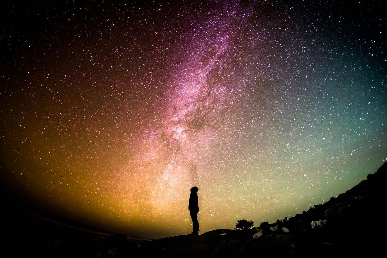 Silhouette of a person gazing at the Milky Way, symbolizing longevity and planning ahead for long-term care and seniors housing.